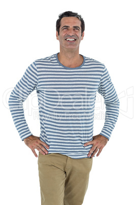 Happy mid adult man with hand on hip