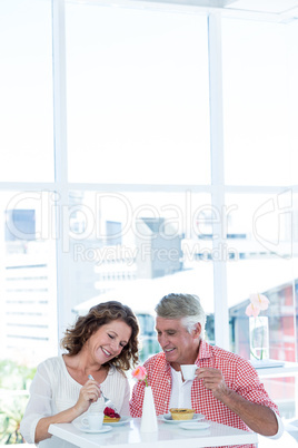 Smiling couple sitting at restaurant