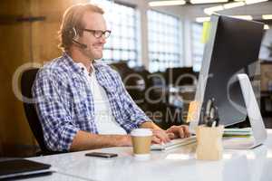 Businessman smiling while working on computer