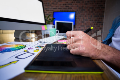 Cropped image of man using graphics tablet