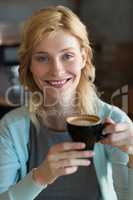 Close-up of beautiful woman having coffee