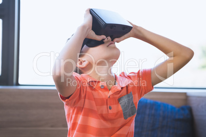 School kid using virtual reality glasses in library