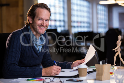 Businessman smiling while working at desk