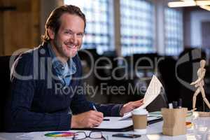 Businessman smiling while working at desk