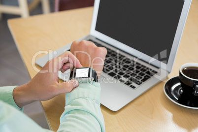 Man adjusting time on his smartwatch