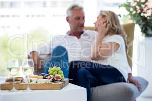 White wine and food on table with couple