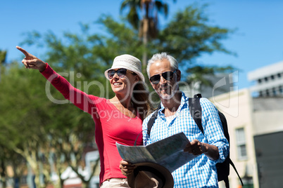 Woman pointing while standing by husband