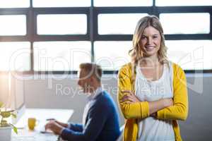 Portrait of smiling woman by colleague in office