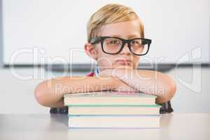 Portrait of schoolkid pretending to be a teacher in classroom