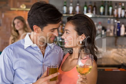 Romantic young couple holding wine glasses