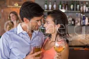 Romantic young couple holding wine glasses