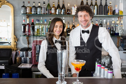 Portrait of waiter and waitress smiling