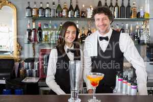 Portrait of waiter and waitress smiling