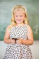 Schoolgirl using mobile phone in classroom
