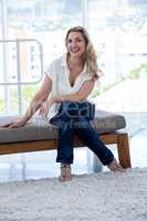 Smiling woman sitting on couch