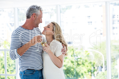 Smiling romantic mature couple with wine glasses