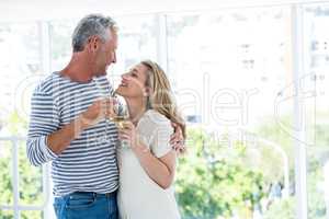 Smiling romantic mature couple with wine glasses