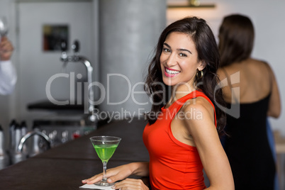Beautiful woman standing with cocktail glass