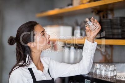 Waitress checking small glass