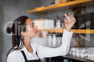 Waitress checking small glass