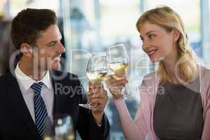 Smiling business colleagues toasting beer glass