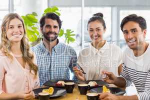Group of happy friends having dessert together