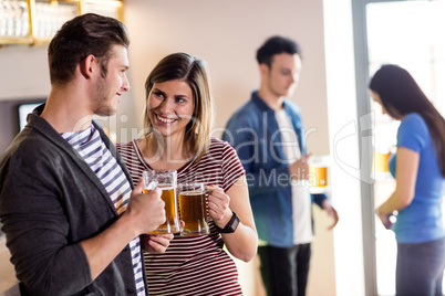 Couple with beer mug in bar