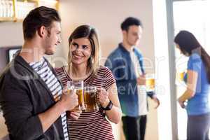 Couple with beer mug in bar