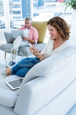 Smiling woman holding mobile phone by man