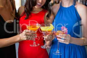 Happy female friends holding glass of cocktail