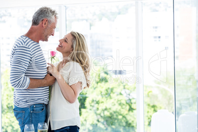 Side view of romantic mature couple with pink rose