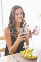 Beautiful woman having wine with meal