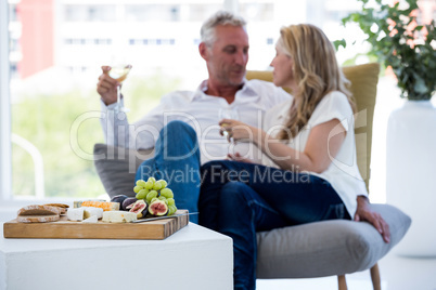 Food on table with mature couple