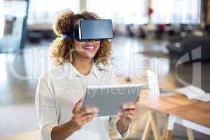 Woman wearing virtual reality glass with digital tablet