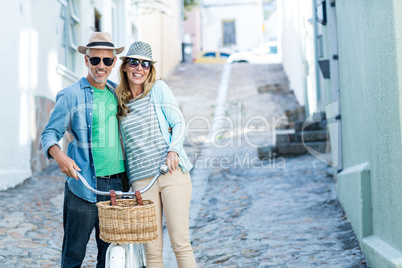 Portrait of mature couple with bicycle