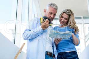 Couple looking in map at home