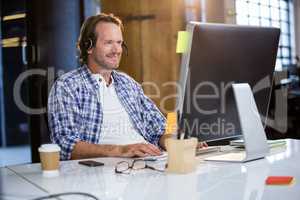 Businessman smiling while using computer