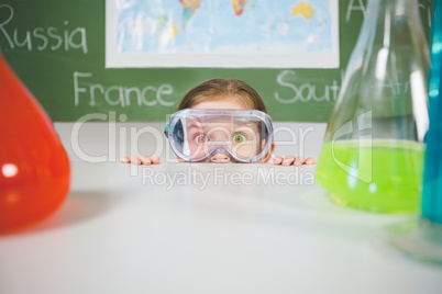 Schoolgirl doing a chemical experiment in laboratory