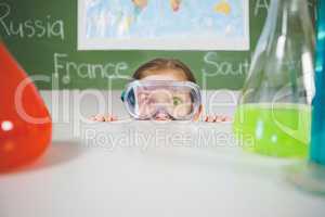 Schoolgirl doing a chemical experiment in laboratory