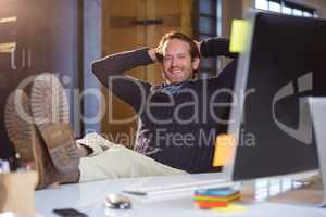 Businessman resting at computer desk