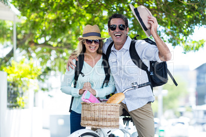 Mid adult couple with bicycle on street