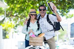 Mid adult couple with bicycle on street