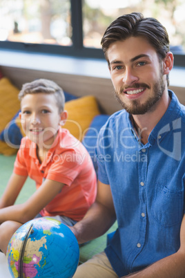 Teacher and kid discussing globe