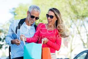 Mature couple holding shopping bags