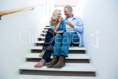 Happy man giving flower to woman