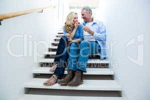 Happy man giving flower to woman
