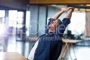 Relaxed man sitting in office