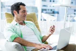 Man using cellphone on couch