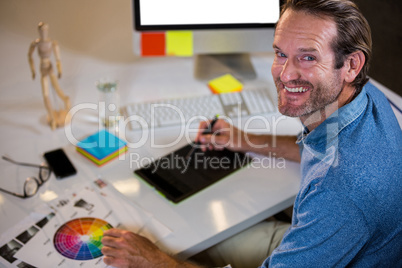 Portrait of businessman using graphics tablet