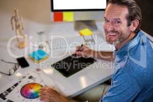 Portrait of businessman using graphics tablet